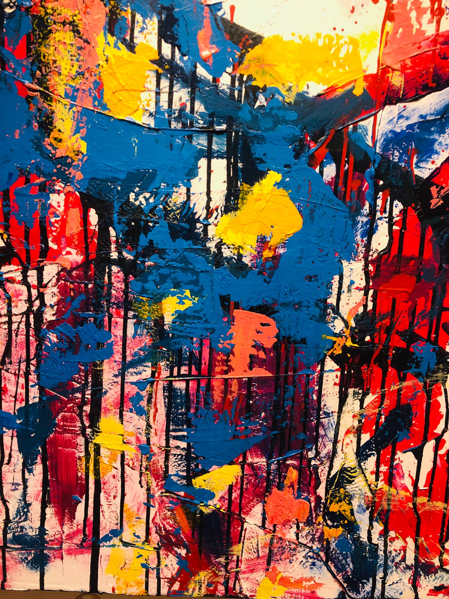 Abstract art with splashes of red, yellow, blue, and pink on a white background