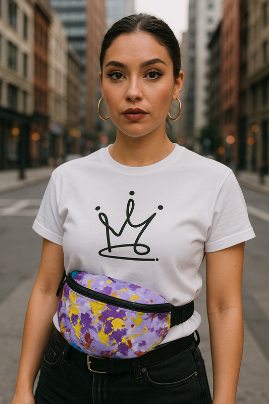 Woman wearing a white t-shirt with a crown design and a colorful fanny pack on a city street.
